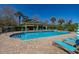 Resort-style community pool with lounge chairs and covered seating area on a sunny day at 5252 Hidden Cypress Ln, Oviedo, FL 32765