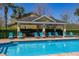 Community pool with ample seating, lounge chairs and a covered seating area at 5252 Hidden Cypress Ln, Oviedo, FL 32765