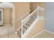 A staircase leading to the upper level of the home with carpeted steps at 5252 Hidden Cypress Ln, Oviedo, FL 32765
