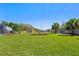 Expansive backyard featuring a lush green lawn, trees, and tidy landscaping at 5337 Foxshire Ct, Orlando, FL 32819
