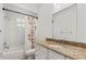 Bathroom featuring a tub with shower and curtain and a granite countertop at 5337 Foxshire Ct, Orlando, FL 32819