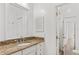 Bathroom featuring a granite countertop and a large mirror at 5337 Foxshire Ct, Orlando, FL 32819