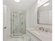 Modern bathroom featuring a glass-enclosed shower with marble-patterned walls and quartz countertops at 5337 Foxshire Ct, Orlando, FL 32819