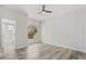 Bright bedroom with hardwood flooring and a view of the landscaped backyard through a large window at 5337 Foxshire Ct, Orlando, FL 32819