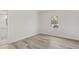 Minimalist bedroom design with light wood flooring, a single window, and en-suite bathroom at 5337 Foxshire Ct, Orlando, FL 32819
