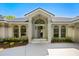 Welcoming front entrance featuring an arched entryway, large windows, and a well-maintained yard showcasing curb appeal at 5337 Foxshire Ct, Orlando, FL 32819