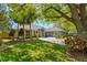 Beautiful single-story home featuring a well-manicured lawn, mature trees, and a circular driveway leading to a 3-car garage at 5337 Foxshire Ct, Orlando, FL 32819