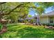 Well-manicured front yard with mature trees and a charming home exterior at 5337 Foxshire Ct, Orlando, FL 32819
