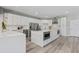 Modern kitchen featuring a large center island, stainless steel appliances, and custom white cabinetry at 5337 Foxshire Ct, Orlando, FL 32819