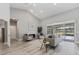 Spacious living room with vaulted ceilings, a fireplace, and sliding glass doors leading to a screened-in pool area at 5337 Foxshire Ct, Orlando, FL 32819