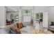 Bright and open living room showcasing modern decor, large windows, and hardwood floors, perfect for entertaining at 5337 Foxshire Ct, Orlando, FL 32819