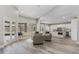 Open-concept living area with view of kitchen, large windows, and access to the pool area, offering a seamless indoor-outdoor flow at 5337 Foxshire Ct, Orlando, FL 32819