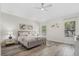 Serene primary bedroom featuring a ceiling fan, natural light, and modern décor at 5337 Foxshire Ct, Orlando, FL 32819
