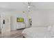 Bright primary bedroom with en-suite bathroom, ceiling fan and view to television at 5337 Foxshire Ct, Orlando, FL 32819