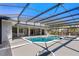 Beautiful screened-in pool with an attached jacuzzi and a view of the backyard at 5337 Foxshire Ct, Orlando, FL 32819