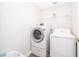 Laundry room featuring modern front loading washer and dryer, plus convenient shelving at 534 Paloma Dr, Davenport, FL 33837