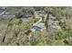 Enjoy a private backyard oasis with a screened-in pool and lush landscaping from this aerial view at 5410 S Pine Hill Cir, Orlando, FL 32808