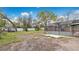 View of the expansive backyard with a screened-in patio and mature trees at 5410 S Pine Hill Cir, Orlando, FL 32808