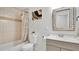 Bathroom with a tub, tiled walls, and vanity with a light gray cabinet at 5410 S Pine Hill Cir, Orlando, FL 32808