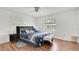 Cozy bedroom featuring a queen bed with wood floors and bright natural light at 5410 S Pine Hill Cir, Orlando, FL 32808