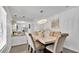Bright dining area with a modern chandelier and seating for six adjacent to the kitchen at 5410 S Pine Hill Cir, Orlando, FL 32808
