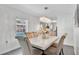 Bright dining area with a modern chandelier and seating for six adjacent to the kitchen at 5410 S Pine Hill Cir, Orlando, FL 32808