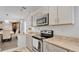 Bright kitchen with stainless steel appliances and granite countertops overlooking the dining area at 5410 S Pine Hill Cir, Orlando, FL 32808