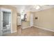 Open living space with tile floors, neutral paint, and seamless kitchen access at 5410 S Pine Hill Cir, Orlando, FL 32808