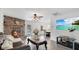 Cozy living room featuring a decorative brick fireplace and elegant leather seating at 5410 S Pine Hill Cir, Orlando, FL 32808