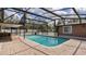 Spacious screened-in pool area with brick paver surround and ample seating space at 5410 S Pine Hill Cir, Orlando, FL 32808