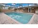 Large screened-in pool area with brick paver surround and clear blue water at 5410 S Pine Hill Cir, Orlando, FL 32808