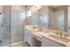 Beautiful bathroom featuring double sinks with marble countertop and tiled shower with glass door at 5640 Nevis Ter, Kissimmee, FL 34758