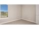 Bedroom with neutral carpeting, base trim and window with a view to the exterior at 5640 Nevis Ter, Kissimmee, FL 34758
