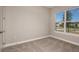 Unfurnished bedroom with neutral carpeting, white trim and a large window with an exterior view at 5640 Nevis Ter, Kissimmee, FL 34758