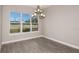 Bright dining room featuring hardwood floors, contemporary chandelier and large window with backyard view at 5640 Nevis Ter, Kissimmee, FL 34758