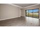 Bright living room with wood-style tile flooring, recessed lighting and sliding glass doors to the backyard at 5640 Nevis Ter, Kissimmee, FL 34758
