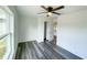 Cozy bedroom features a large window and hardwood floors at 7 Locust Run, Ocala, FL 34472