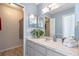 Bathroom vanity featuring dual closets and a view back to the bedroom at 7507 Pacific Heights Cir, Orlando, FL 32835