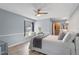 Comfortable bedroom featuring wood-look floors, a ceiling fan, and a window seat at 7507 Pacific Heights Cir, Orlando, FL 32835