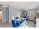 Dining area featuring stylish table, bright chandelier, and open access to the kitchen at 7507 Pacific Heights Cir, Orlando, FL 32835