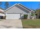 Charming single-Gathering home featuring a two-car garage and a well-maintained lawn at 7507 Pacific Heights Cir, Orlando, FL 32835