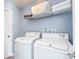 Laundry room with a washer and dryer and overhead storage at 7507 Pacific Heights Cir, Orlando, FL 32835