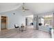 Bright living room featuring vaulted ceilings, modern flooring, and a large window at 7507 Pacific Heights Cir, Orlando, FL 32835