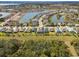 Aerial view of the neighborhood showing the lake, landscaping, and homesites at 8400 Bridgeport Bay Cir, Mount Dora, FL 32757