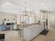 Open-concept kitchen with a breakfast bar that flows into a large living area, featuring modern appliances and finishes at 8400 Bridgeport Bay Cir, Mount Dora, FL 32757