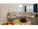 Cozy living room with a plush sectional sofa, a colorful rug, and modern decor at 8400 Bridgeport Bay Cir, Mount Dora, FL 32757