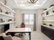 Bright office with floating shelves, custom cabinets, and a modern ceiling fan at 8400 Bridgeport Bay Cir, Mount Dora, FL 32757