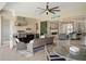 Outdoor kitchen with a built-in grill, bar, and comfortable seating area at 8400 Bridgeport Bay Cir, Mount Dora, FL 32757