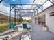 Screened-in pool with sun loungers, outdoor kitchen and meticulous landscaping at 8400 Bridgeport Bay Cir, Mount Dora, FL 32757
