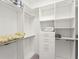Walk-in closet featuring custom shelving and ample storage space at 8400 Bridgeport Bay Cir, Mount Dora, FL 32757